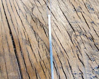 Stick necklace. "The" minimalistic piece of jewellery. Brushed finish.