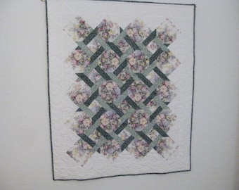 Handmade floral lattice quilt in greens and floral prints which can be a wallhanging.