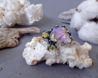 a silver ring inlaid with Australian crystal opal and Baltic amber
