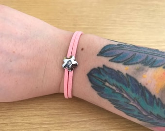 Pink faux suede bracelet with flower charm