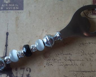 Metal bottle opener with beads