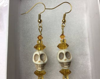 Skull earrings with yellow glass beads