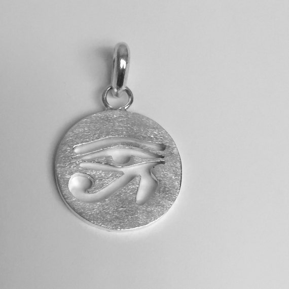 Eye of Ra charm in sterling silver. The Eye of Ra is an ancient Egyptian symbol of protection, royal power and good health.