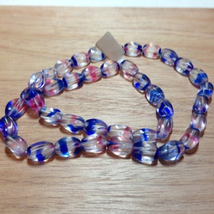 Strand of Oval Flag Colored Preciosa Czech Pressed Beads (Approx. 40 beads)