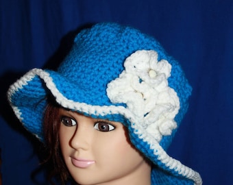 Hat with large blue rim with white flowers