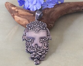 Sterling Art Nouveau repousse pendant