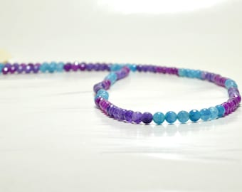 Long necklace with purple and blue beads .