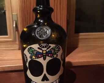 Painted recycled bottle of a sugar skull