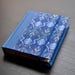 Beautiful sticky note pocket case. It includes notes, bookmarks and closes with rubber band.