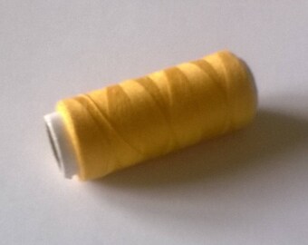 Yellow sewing thread spool 365 m