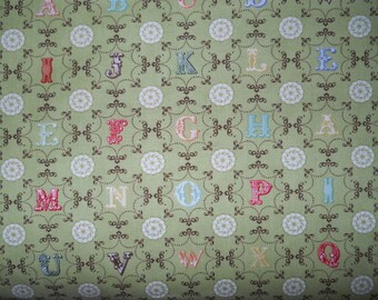Odds and Ends alphabet with design on green By Julie Comstock of Cosmo Cricket for moda retro , with a twist 1 yard cotton quilt fabric