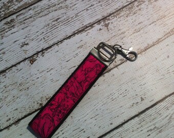 Pink and black rose print key fob wristlet on black cotton webbing with swivel lobster clasp