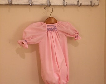 Pink smocked drawstring gown.