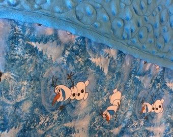 Olaf print in all cotton.the backing is a turquoise minky,and Machine quilted by me. An heirloom quality quilt.