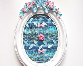 Textile art, Textile painting, shabby chic weaving in an oval white frame with a blue and pink baroque decoration