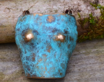 Bust pendant in patinated bronze