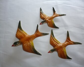 Ceramic flying swallows . Wall hanging .
