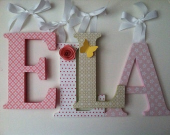 Wooden letters for nursery spelling out your child's name in pink and green