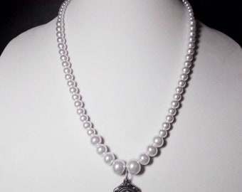 White Cameo Pearl Necklace: 23" white Czech glass pearl necklace with skeleton cameo pendant. Portion of sale goes to charity.