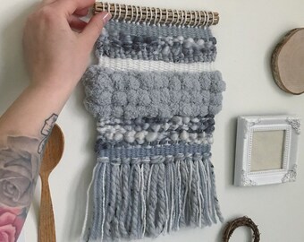 Bohemian woven tapestry wall hanging in gray, taupe & white color palette. Woven of yarn, clouds, and fog. Size 8" x 12".