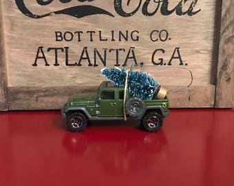 Green Jeep Carrying Christmas Tree Ornament