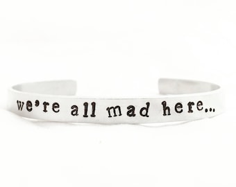 We're all mad here bracelet. Alice in Wonderland cuff. Handstamped book quote jewlery.