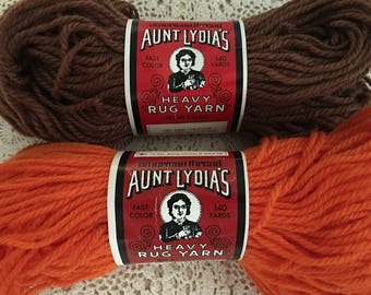 2 skeins rug yarn Aunt Lydia’s heavy (1) 140 yards #420 brown (1) 140 yards # 315 tangerine craft supplies