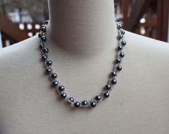 Grey necklace woven with glass beads