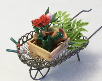 Mini wheel barrel stuffed with potted flowers and garden tools: Fairy or gnome Garden miniature terrariums