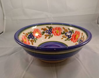 A Beautiful Handmade Ceramic Pottery Bowl painted with flowers.