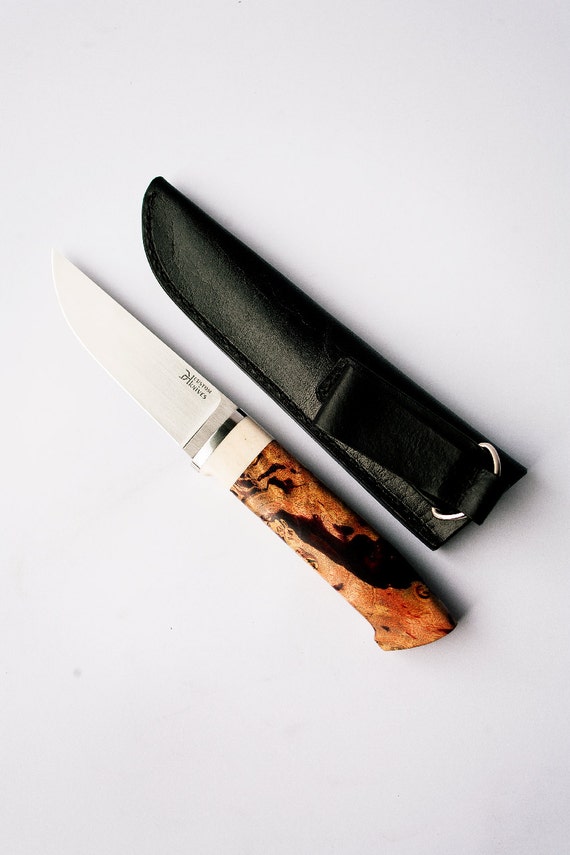 Finish knife with elk horn insert. Quality leather sheath.