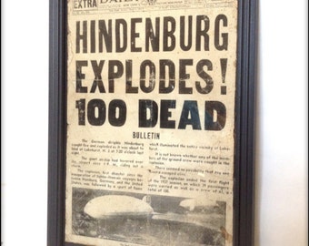Reproduction Hindenburg Disaster newspaper front cover in frame.