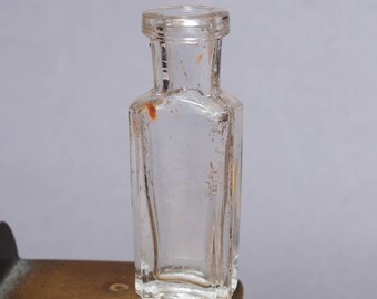 Antique miniature clear glass bottle, medical or laboratory bottle.