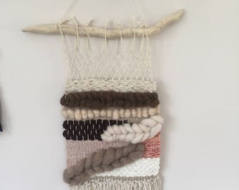 Woven wall hanging on driftwood