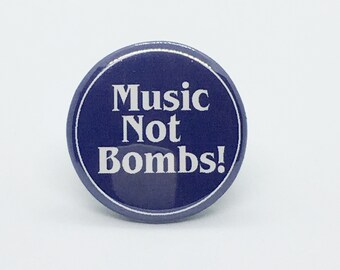 Music Not Bombs! - 1 1/4" Pin, Zipper Pull, Keychain, Magnet or Hair Tie