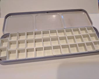 Travel sketchbook Watercolor paint palette with magnetic removable pans. Ebosssed case holds 35 half pans. Pocket size! 8.25x2.5 x .75 in
