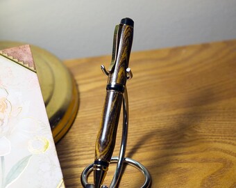 This is a hand crafted Cigar Style pen made from exotic Bacote wood.