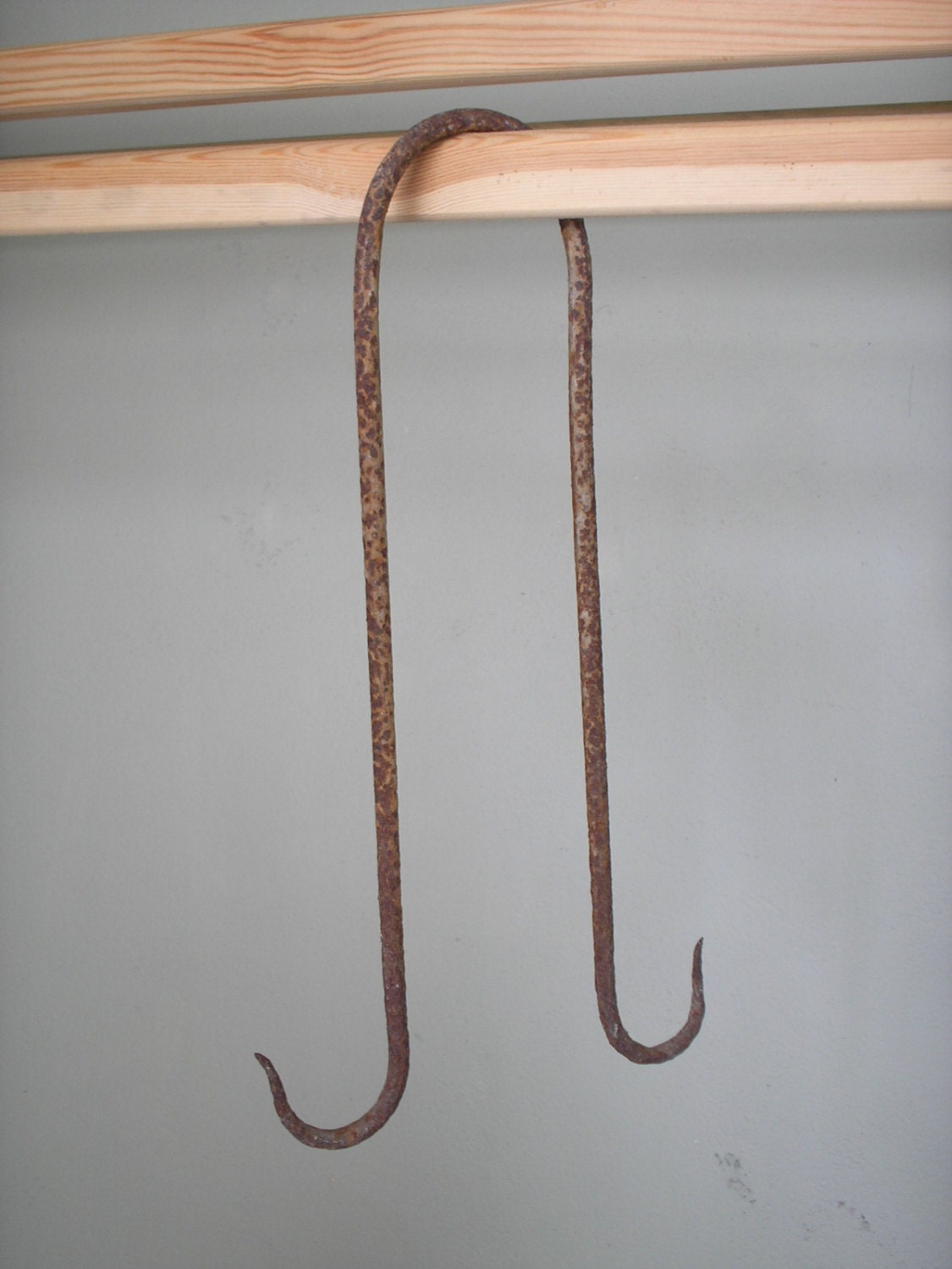 Butcher's double meat hook. Rusty iron rustic farm hand