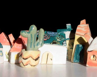 Handmade ceramical nice little houses to decorate any shelf and any kind of interior.