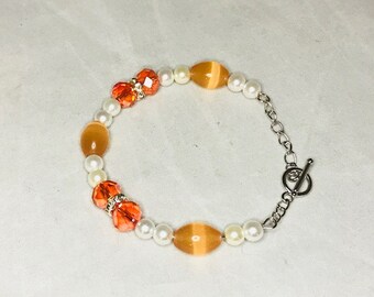 Orange and white memory wire beaded bracelet