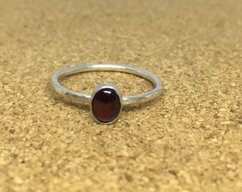 Handmade sterling silver hammered ring with a garnet gemstone