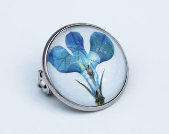 Blue pressed flower brooch