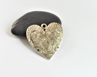 Antique patterned silver plated heart charm pendant.