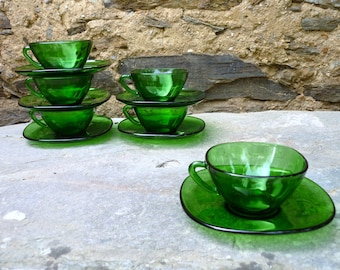 Six French 'vereco' green glass coffee/tea cups and saucers