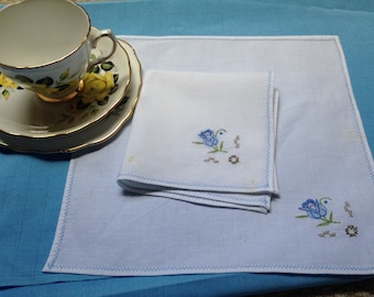 Two vintage linen napkins with blue rose embroidery