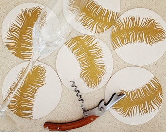 Set of eight gold feather letterpress coasters