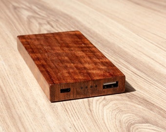 A USB power bank made with Curly Etimoe wood .