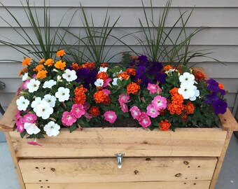 Hose holder with built in flower pot