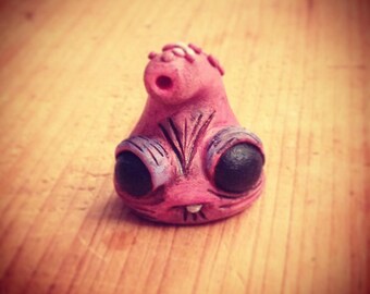Pink Monster mini sculpture with trunk on the head