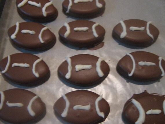 One dozen chocolate covered football shaped Oreos